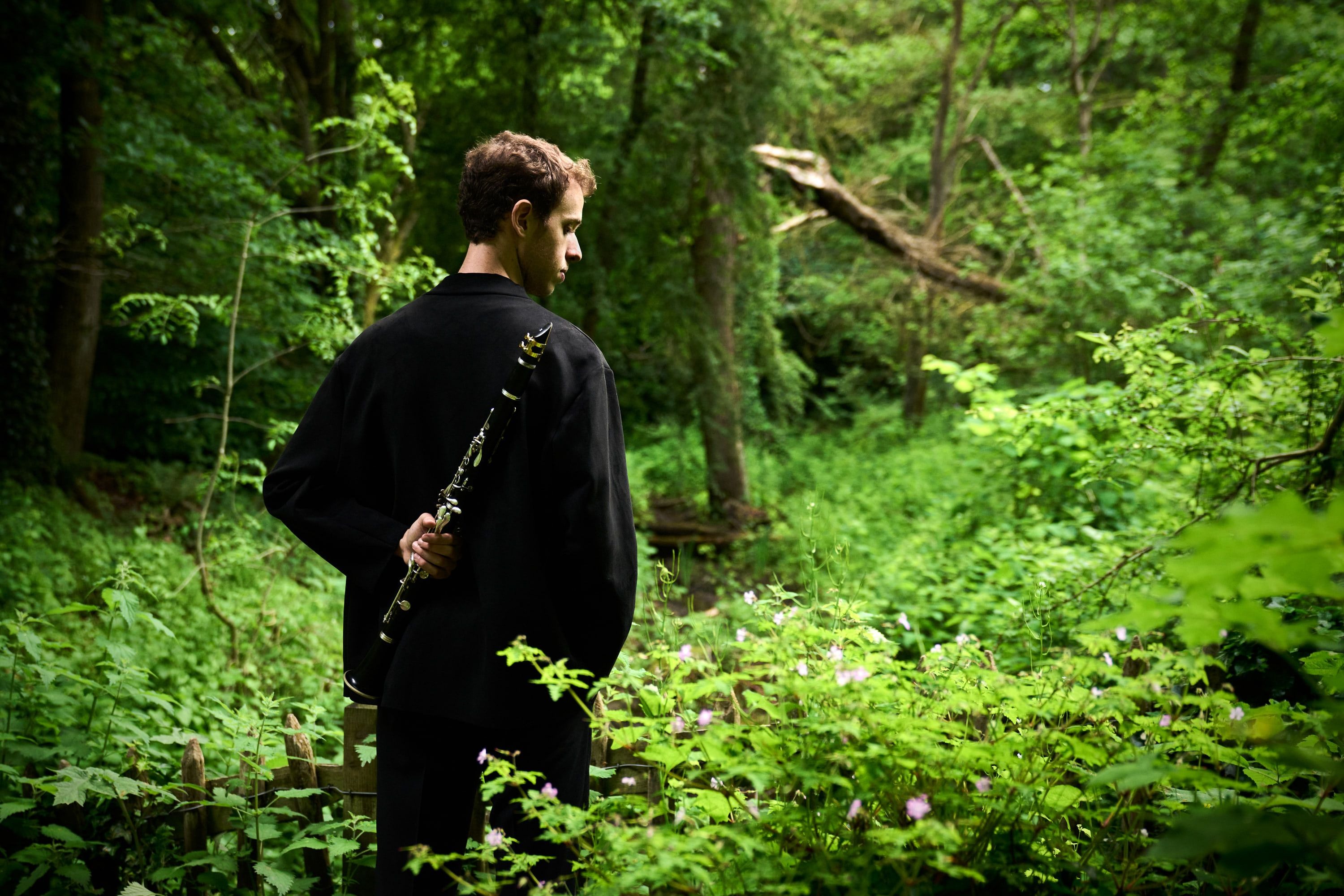 Jonathan Leibovitz seen from behind among ferns and trees