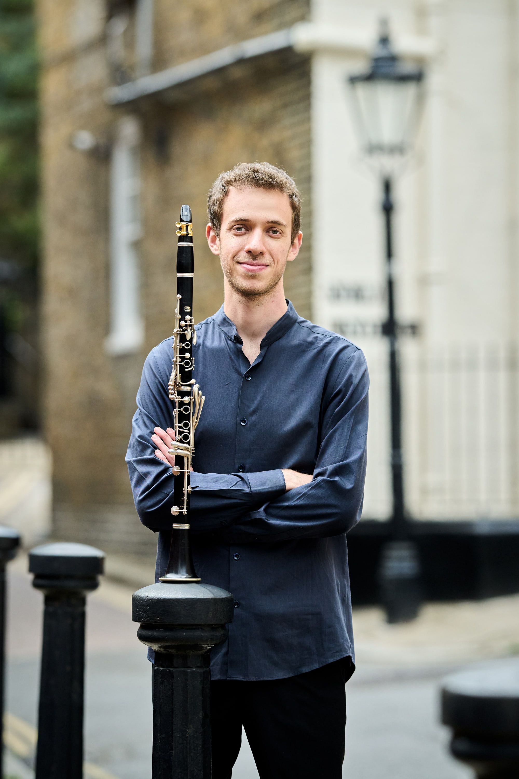 Jonathan Leibovitz on a city street, his clarinet upright beside him